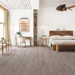 Driftwood oak effect LVT flooring laid in a bedroom
