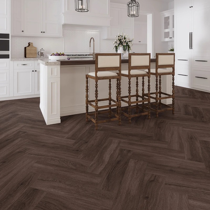 Dark umber effect herringbone LVT flooring laid in a living room