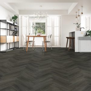 Ebony oak effect herringbone LVT flooring laid in a living room