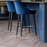 Heather grey effect herringbone LVT flooring laid in a kitchen
