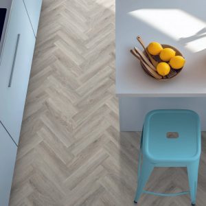 Pebble shore effect herringbone LVT flooring laid in a kitchen
