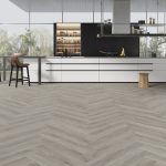 Pebble shore effect herringbone LVT flooring laid in a living room