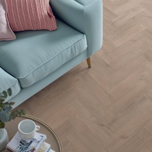 Willow oak effect herringbone LVT flooring laid in a living room